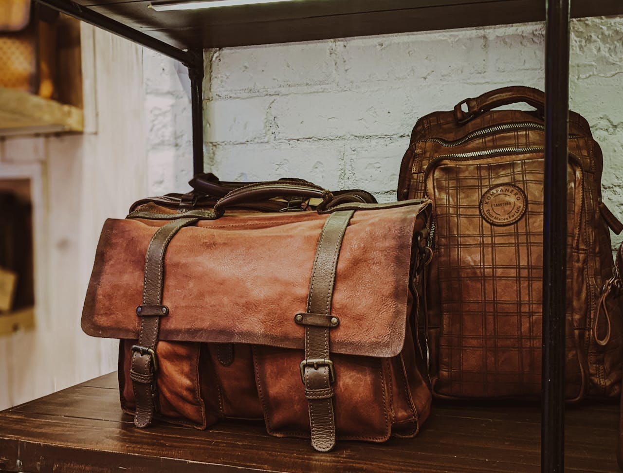 services-01 A selection of vintage leather bags on display in a Bengaluru store, showcasing craftsmanship and style.