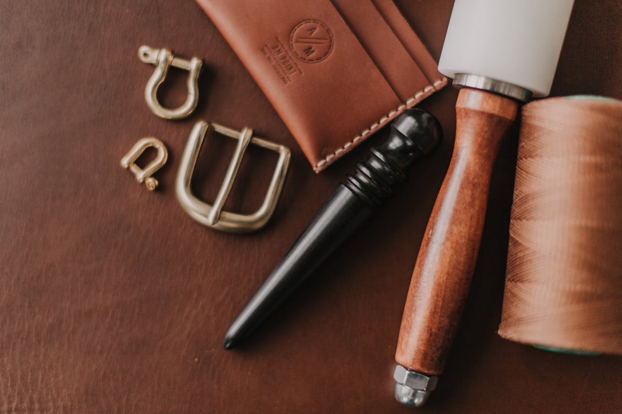 Close-up of leather crafting tools and materials, showcasing handcrafted techniques and equipment.